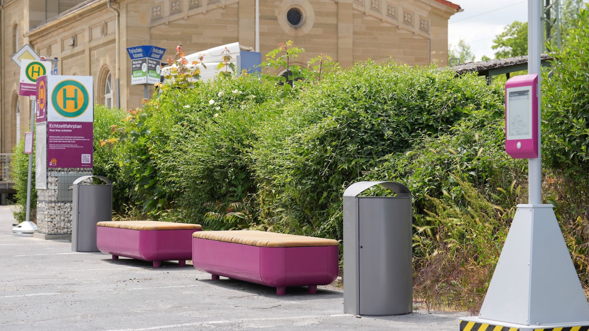 Signs and benches at the bus stop for the replacement service